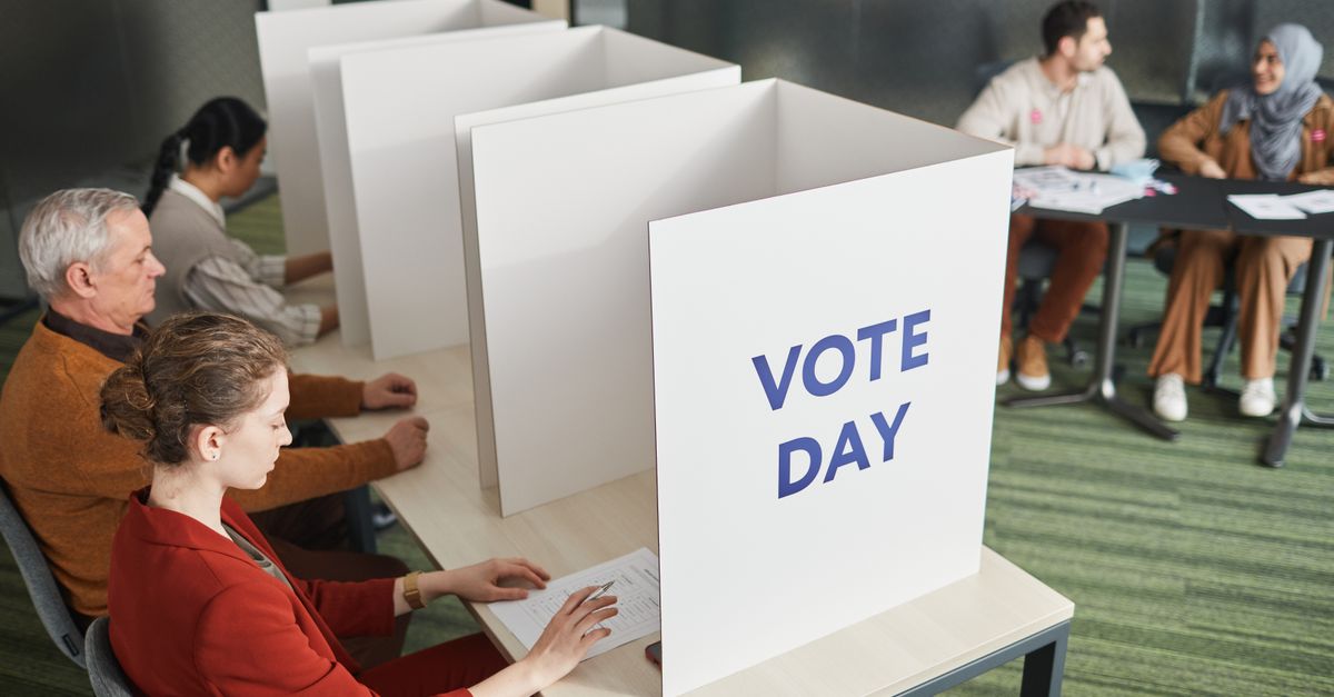 People casting votes in a polling station on election day, emphasizing civic engagement.